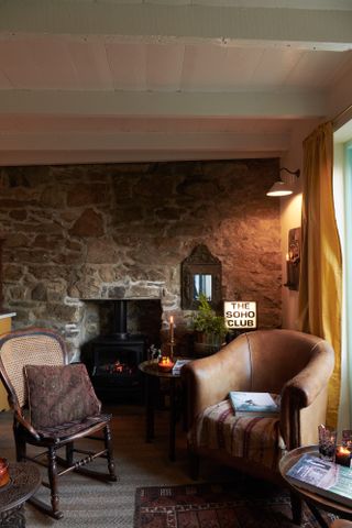 Brown armchair and stone wall