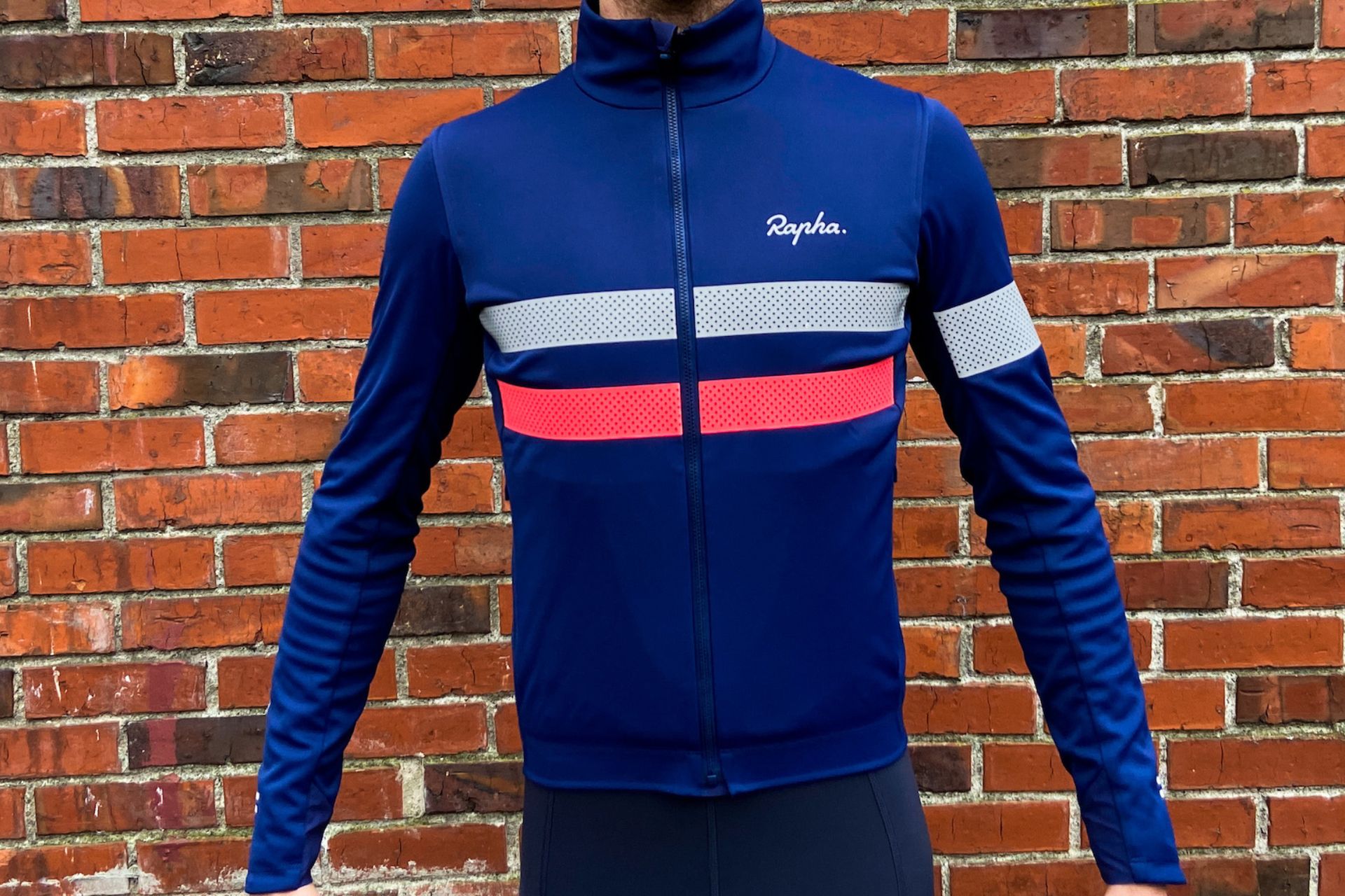 Image shows a rider wearing the Rapha Brevet Infinium which is one of the best winter cycling jackets