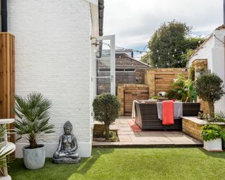 L shaped garden with patio area and artificial turf lawn