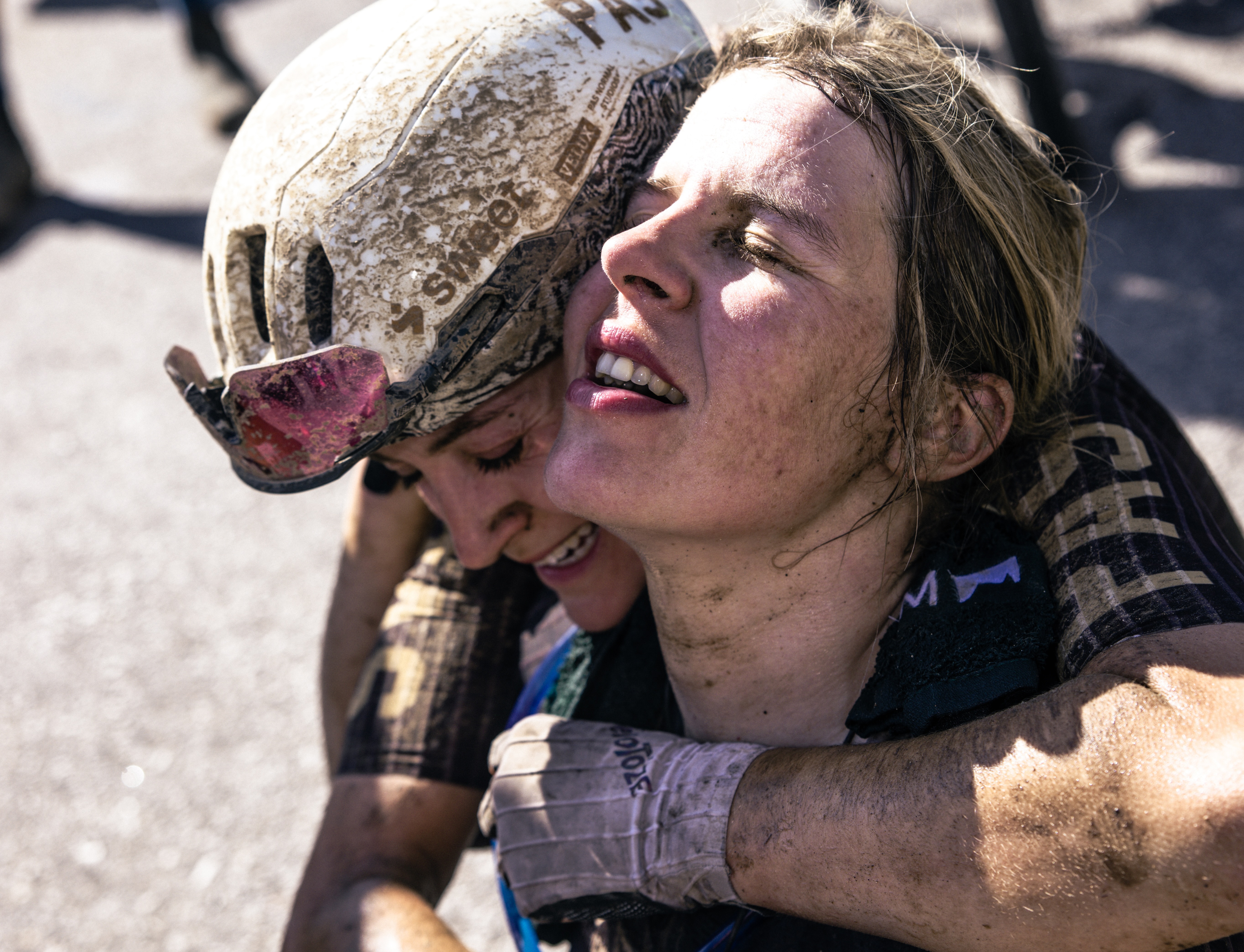 Romy Kasper (right) gets a hug at the finish line in Emporia, Kansas from PAS Racing teammate Morgan Aguirre as duo end day of chasing in top 11, Kasper taking sprint for seventh.