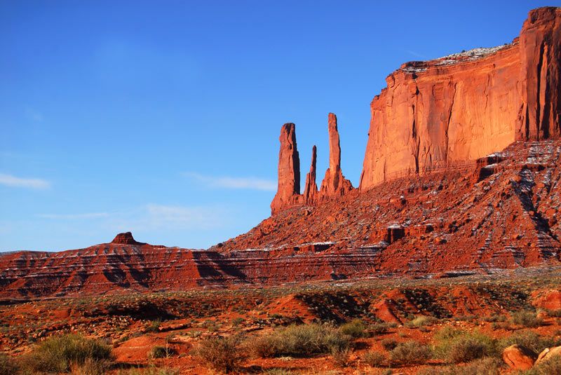 The Three Sisters rock formation found in the Navajo nation land of Monument Valley 