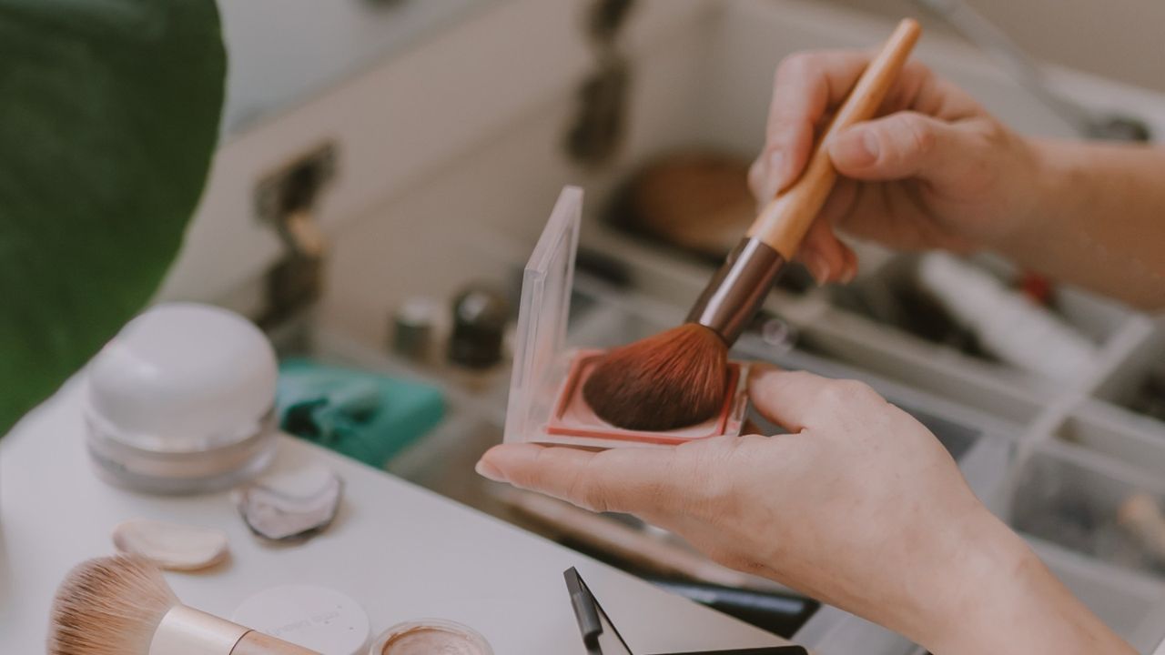 Cropped Hand Of Woman Holding Make Up Brush - stock photo