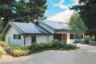 Solar panels on the roof of a detached house with a driveway