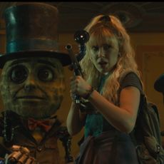 millie bobby brown and a team of robots wield weapons in a still from the movie the action state