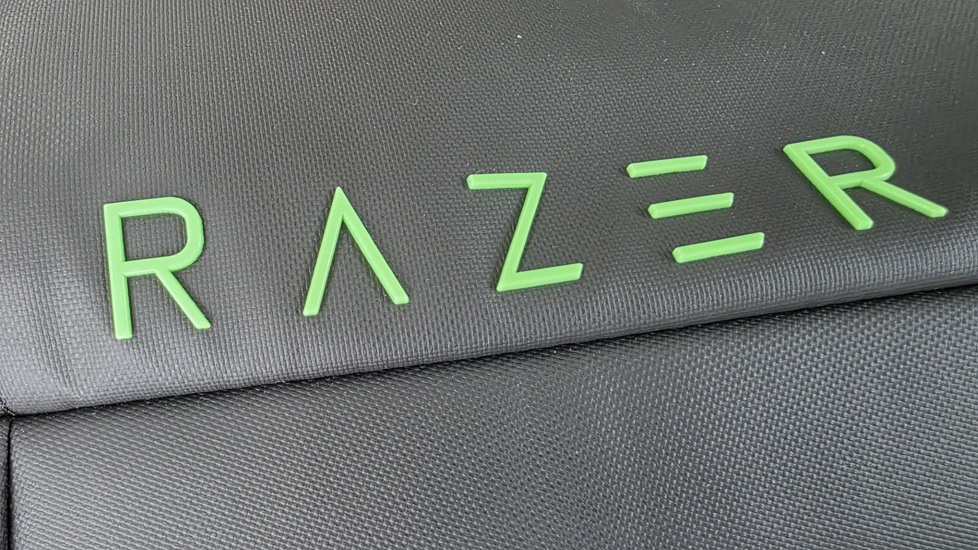 A black Razer backpack, photo zoomed in on razer typeface