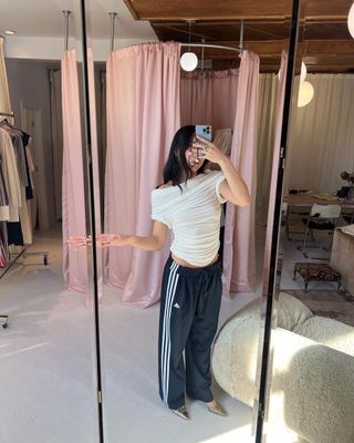 Instagram Trends 2024: Vivian pairs her track pants with an asymmetric top.