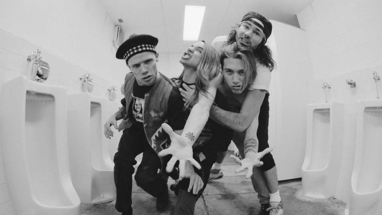 Red Hot Chili Peppers clowning around in a urinal in Japan