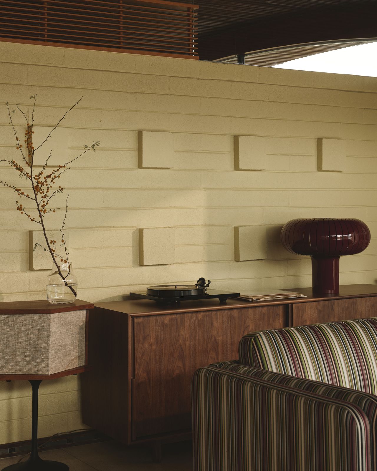A Californian desert house from the mid 20th-century is furnished with earthy, stripy furnishings and iconic design pieces.