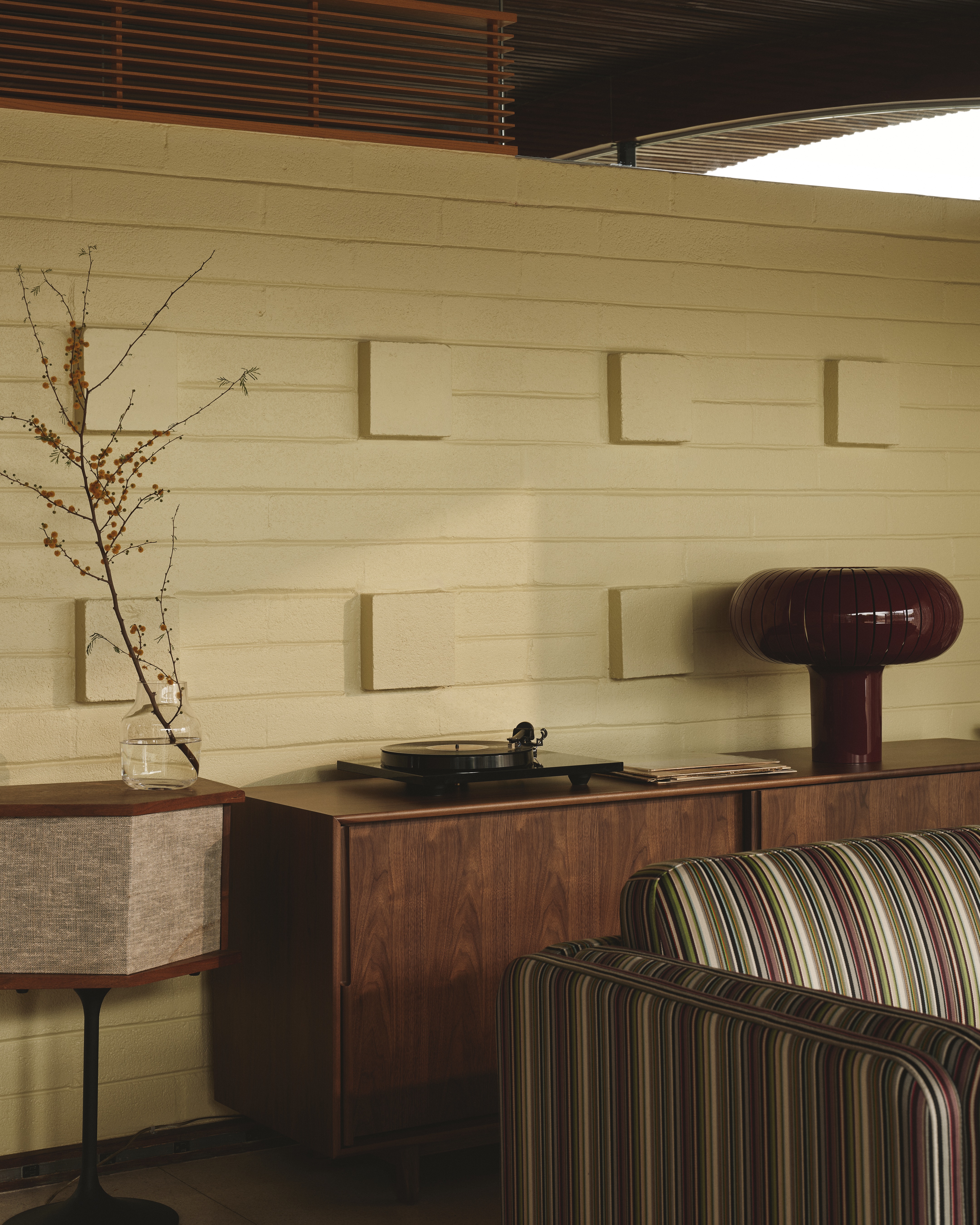 A Californian desert house from the mid 20th-century is furnished with earthy, stripy furnishings and iconic design pieces.