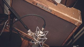 Closeup of a mic'd up Fender guitar amplifier