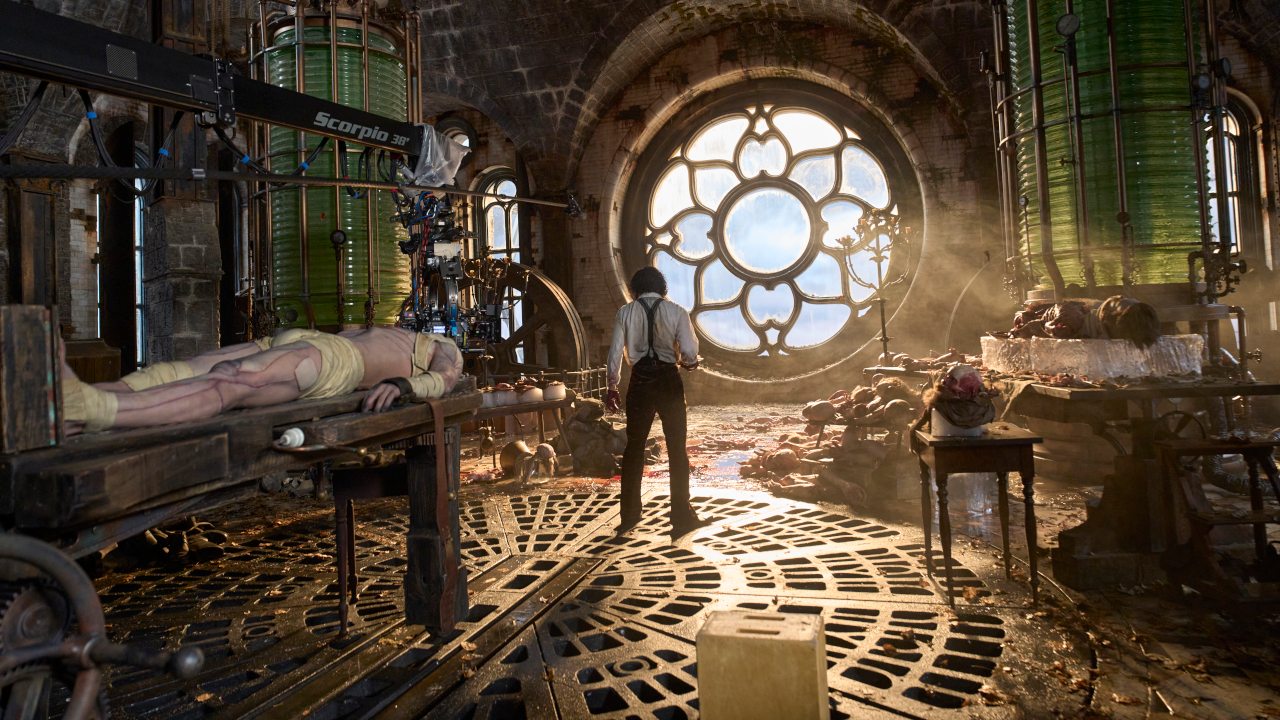 Oscar Isaac stares out a window in his spacious lab in Frankenstein.