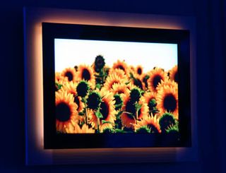 The TV is surrounded by light sources that change color depending on the TV image.