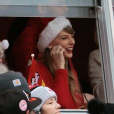 Taylor Swift wearing a Santa hat while in the stadium at a Kansas City Chiefs Game on Christmas Day in 2023.