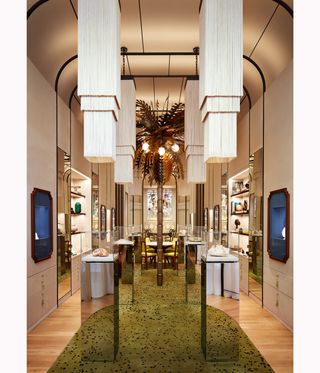 interior of Irene Neuwirth Madison Avenue store with central palm tree artwork and fringed chandeliers