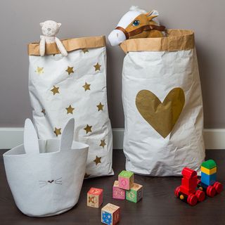 paper bags with toys and wooden floor