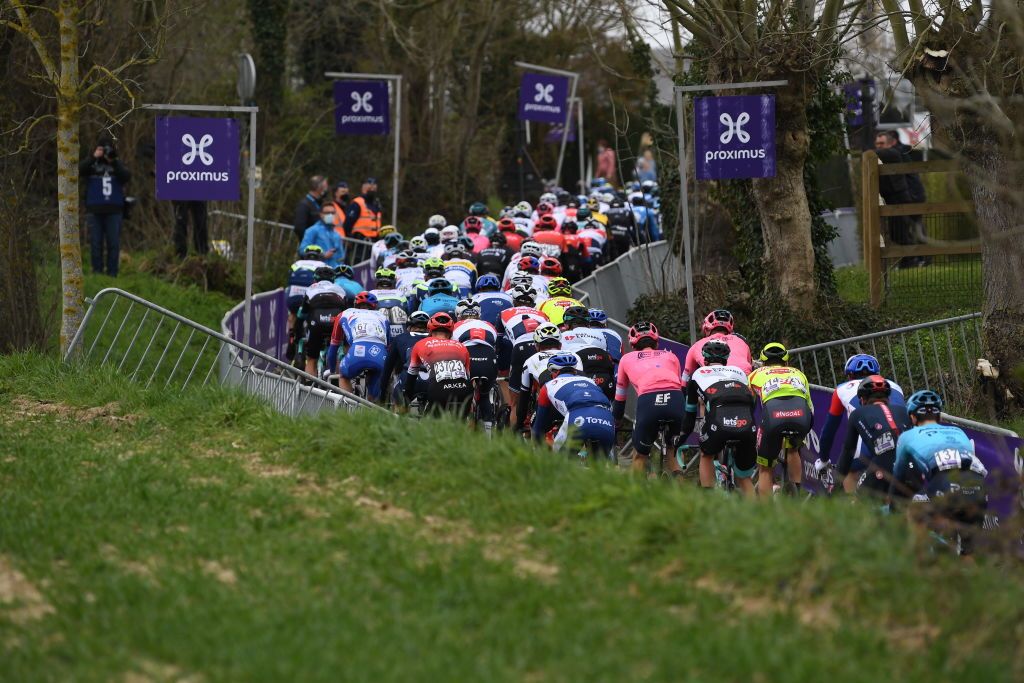 OUDENAARDE BELGIUM APRIL 04 The Peloton passing through Oude Kwaremon Cobblestones sector during the 105th Ronde van Vlaanderen Tour of Flanders 2021 Mens Elite a 2515km race from Antwerp to Oudenaarde Landscape RVV21 rondevanvlaanderen tourofflanders on April 04 2021 in Oudenaarde Belgium Photo by Tim de WaeleGetty Images