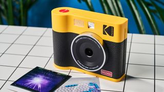 A black and yellow Kodak Mini Shot 3 Era 2-in-1 instant camera and printer