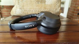 Sony ULT Wear over-ear headphones side on view on wooden table