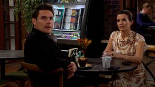 Mark Grossman and Melissa Claire Egan as Adam and Chelsea looking at someone in The Young and the Restless