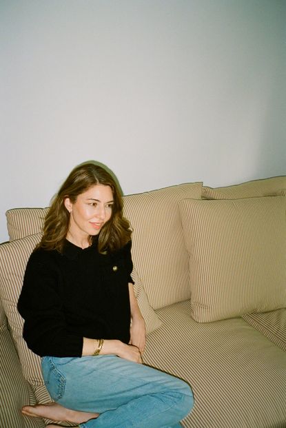 Sofia Coppola on sofa wearing Barrie jumper