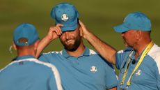 Jon Rahm of Team Europe is congratulated by Thomas Bjorn, Vice Captain of Team Europe during the Friday afternoon fourball matches of the 2023 Ryder Cup at Marco Simone Golf Club