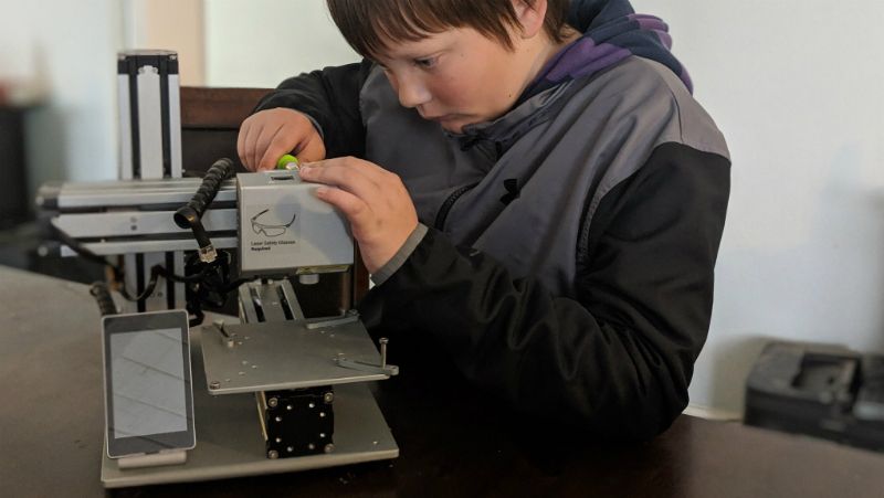 Boy fixing printer