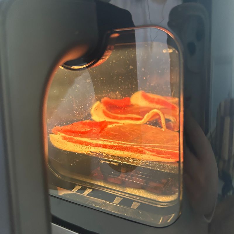 Cuisinart Tri Zone 13.6L Air Fryer &amp;amp; Oven - cooking bacon through the viewing window