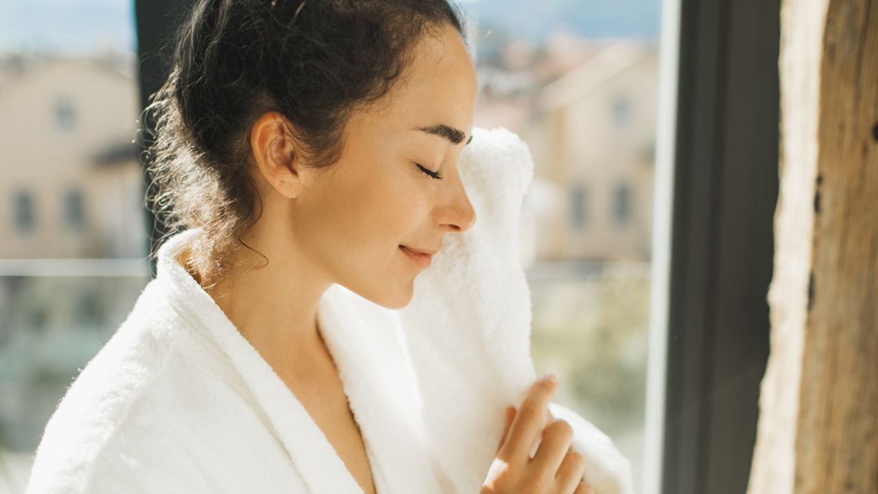 La Roche-Posay Toleriane Dermo Cleanser - image of woman washing face with white flannel