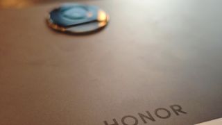 A SPace Grey Honor Pad 9 tablet on a brown table