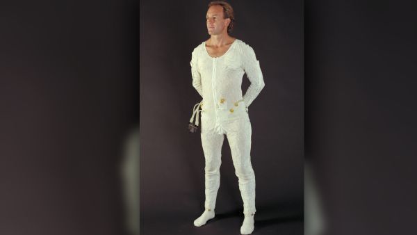 A man models an astronaut undergarment — known as a Liquid Cooling and Ventilation Garment — that was designed for the Space Shuttle/International Space Station Extravehicular Mobility Unit, photographed in 1994.