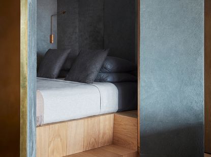 black bedroom with a nook and a wood step