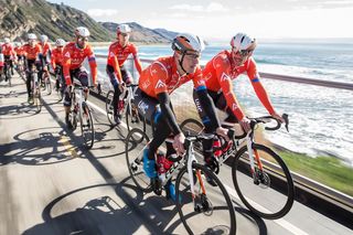 Gavin Mannion and Colin Joyce lead a Rally UHC ride along the Pacific Ocean