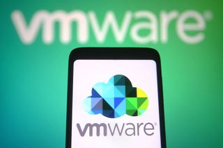 A smartphone with the VMware logo displayed on screen, in front of a green background with another VMware logo displayed