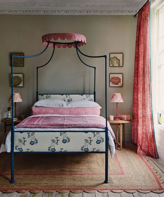 A pretty bedroom scheme with blue painted four poster bed and pretty pink textiles