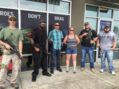 Armed civilians outside of an Army recruiting center.