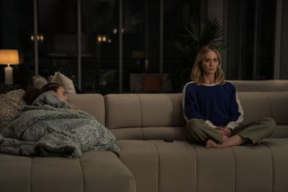 Emily Blunt sat on a sofa in Pain Hustlers