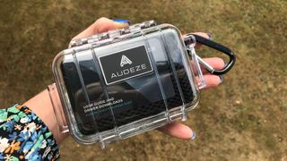 Audeze Euclid reinforced packaging, with carabiner, on green background