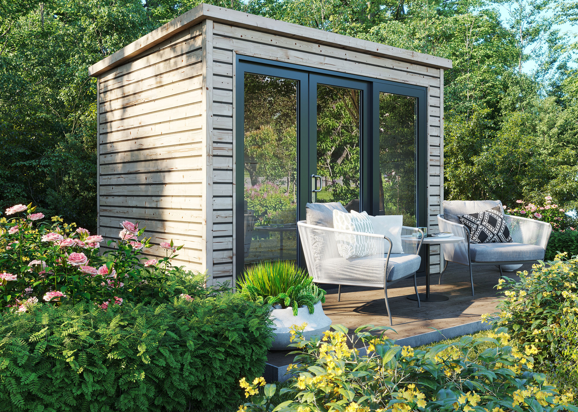 modern garden shed with glazing and double doors, with small patio/deck in front with garden chairs, and planting all around featuring flowering shrubs