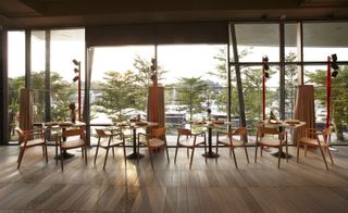 Wooden tables & chairs in front of large window