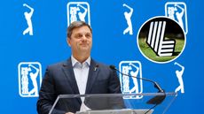 Brian Rolapp stands at a podium smiling during his pre-Players Championship press conference with a LIV Golf Logo inset in the top-right corner
