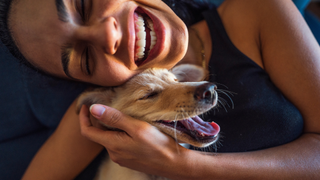 Woman hugging a dog and smiling