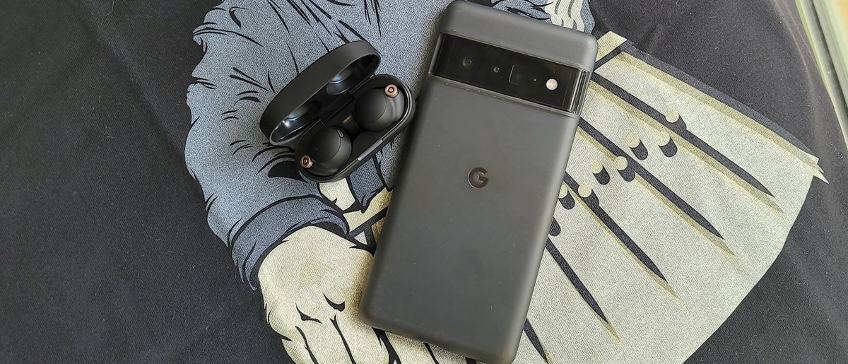 The Sony WF-1000XM4 sitting next to the Google Pixel 6 Pro