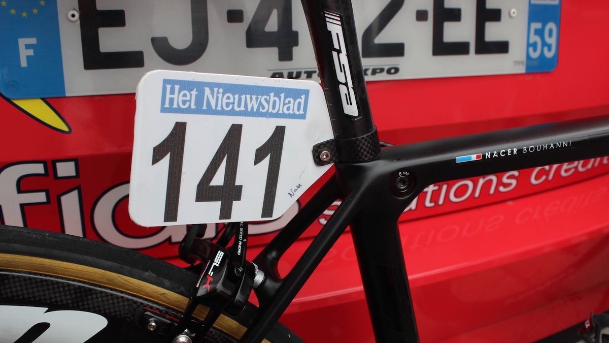 The blacked out bike features a svelte carbon race number holder