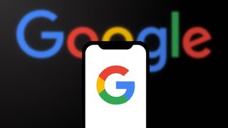 Google logo on phone with Google Logo in background