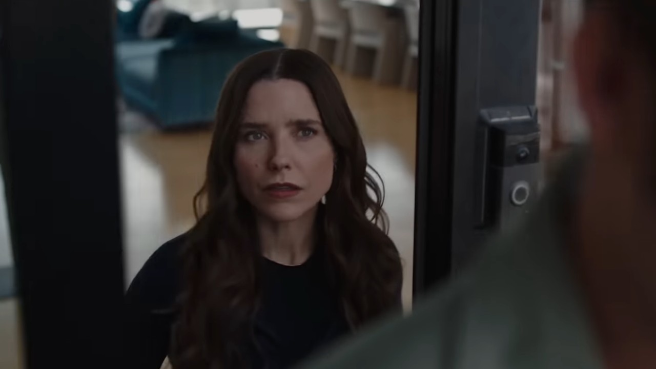 Sophia Bush opening door in The Stranger in My Home. 