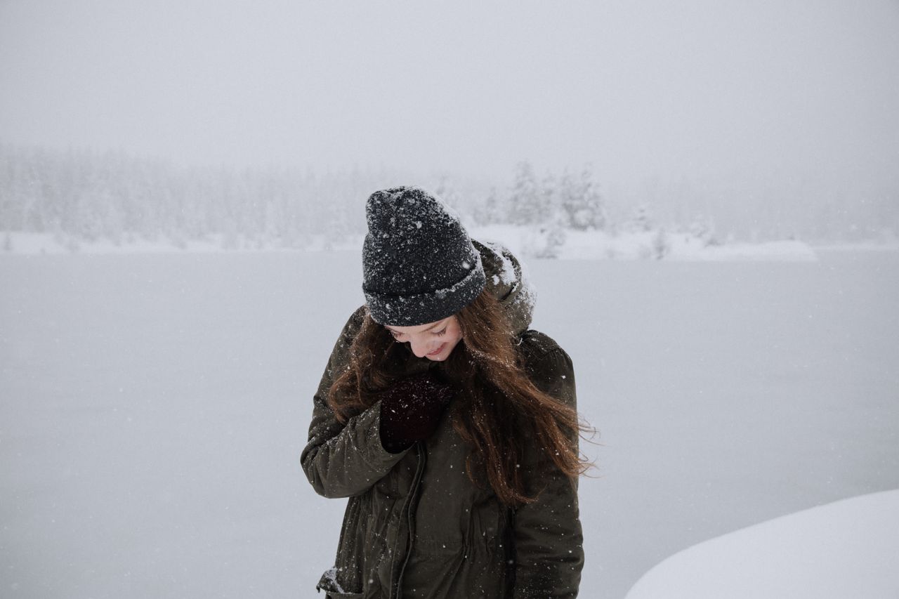 A woman wearing a winter coat in the snow