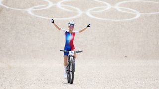 Pauline Ferrand-Prévot of Team France celebrates at finish line as race winner at the Women’s Olympic Cross-Country MTB in Paris