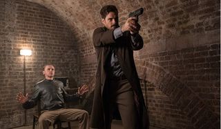 Mission: Impossible - Fallout Henry Cavill aims a gun, while Simon Pegg watches