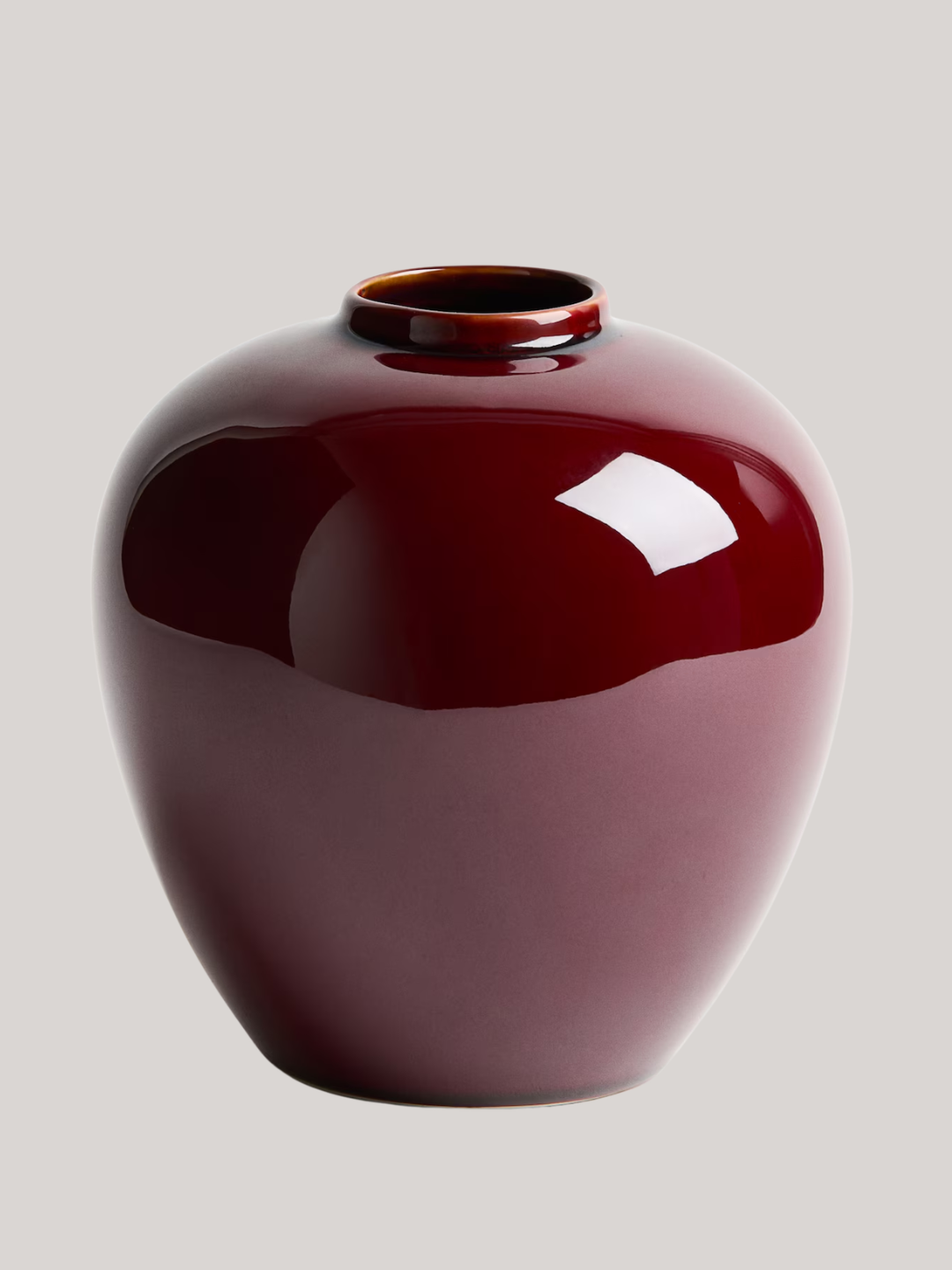 A glossy burgundy stoneware vase from H&amp;amp;M