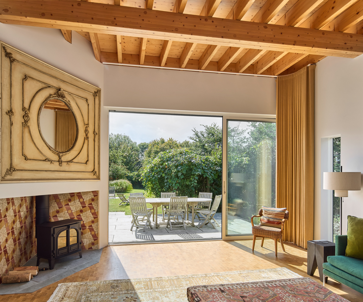 Living room with fireplace featuring sliding doors leading onto dining patio area